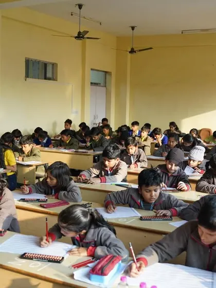 A large classroom of students, all working diligently with their abacus and worksheets.