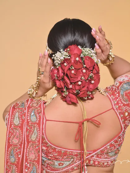 A close-up of the intricate floral bun, showing the hairstyling skills taught at the academy.