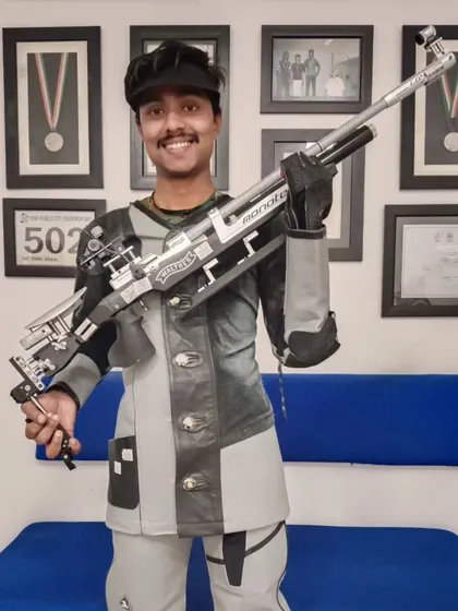 Tahzeeb Khan proudly displays his Walther rifle after becoming a "Renowned Shot" at the 67th National Shooting Championship. His discipline and tireless effort have set him apart.