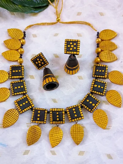 A bold black and gold version of the square and leaf necklace.