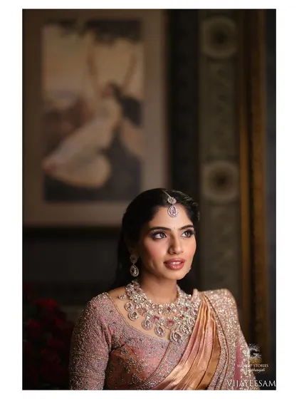 A beautiful candid style portrait of Ashitha. Her makeup looks soft and radiant, with a focus on luminous skin and a subtle pink lip that enhances her natural beauty.