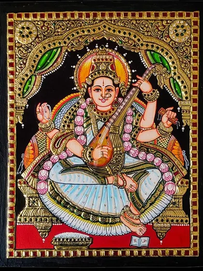An unframed, detailed view of our Saraswati Tanjore painting. The craftsmanship shines through in the delicate lines, the texture of the gold foil, and the harmonious color palette.