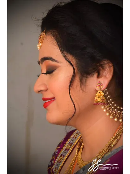 This profile shot showcases the clean lines of the eye makeup and the smooth, non-cakey skin finish, ensuring the bride looks flawless throughout her engagement ceremony.