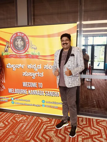 Posing in front of the welcome banner for the Melbourne Kannada Sangha. I was thrilled to be there to entertain the Kannada community.