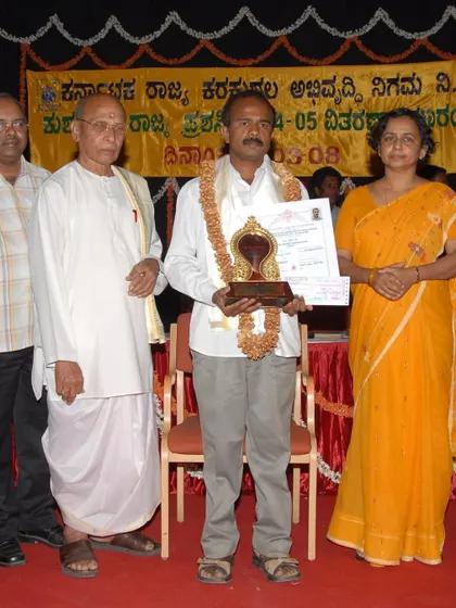 Holding the Karnataka State Award trophy and certificate. It is an honor to contribute to the legacy of this traditional art form.
