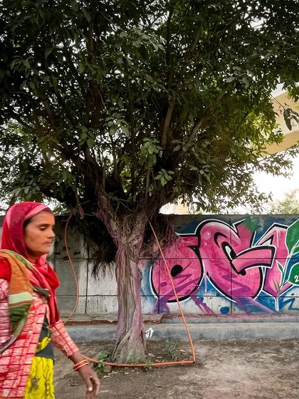 A candid shot of a woman walking past my finished piece. Public art becomes part of the daily lives of the people around it.