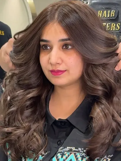 A side view of the beautiful mocha brown no bleach color. You can see the incredible volume and how the layers are styled away from the face to create a soft, open look.