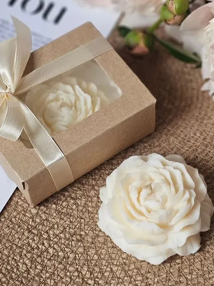 A single peony candle, beautifully packaged in a rustic box with a window. It's a perfect gift for any occasion.