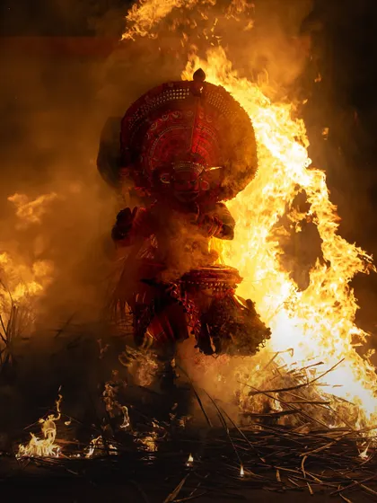 A sequence documenting the Kandanar Kelan Theyyam's fearless dance through fire. These images show the performer's complete surrender to the flames, a testament to the ritual's power.