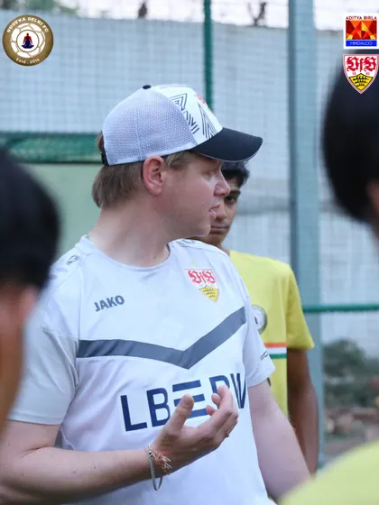 A VfB Stuttgart coach gives tactical instructions to the team. Clear communication and a deep understanding of the game's strategy are key takeaways from these sessions.