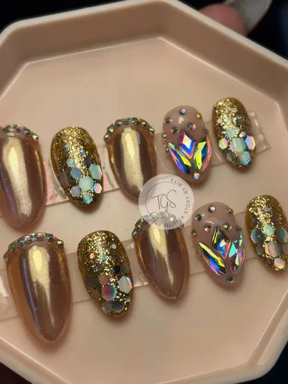 A complete, ready-to-ship bridal press-on set. This design features a mix of gold chrome, glitter, and hand-placed iridescent crystals, showing the variety of styles possible in a single set.