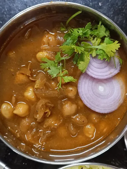 Another serving of my delicious chole, ready to be enjoyed. The chickpeas are cooked until perfectly tender in a spiced tomato and onion gravy.