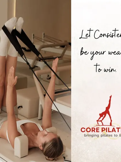 Let consistency be your weapon to win. This image captures a client performing leg lowers with straps, a classic Pilates exercise for building deep core strength.