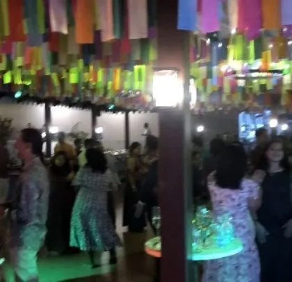 Guests enjoying the party under a ceiling of colorful streamers.