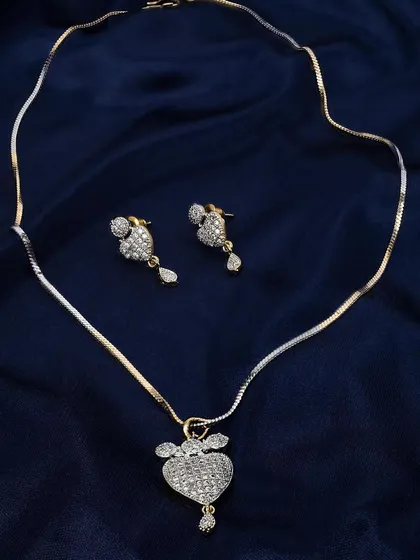 A diamond pendant and earring set displayed on a luxurious blue fabric. This shot is perfect for showcasing gift sets or matching jewelry collections.
