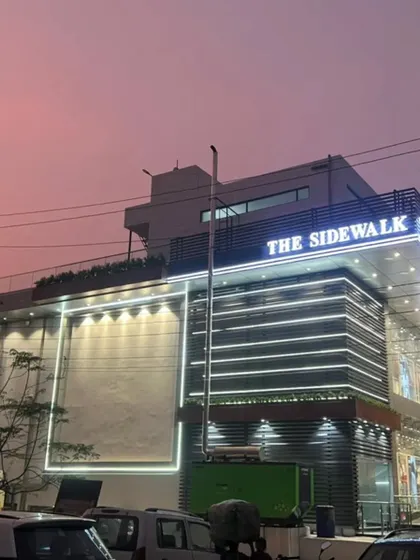 Another view of "The Sidewalk" exterior, showcasing the clean lines, cladding, and lighting design that make it a local landmark.