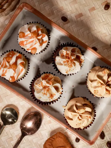 An overhead shot of our assorted cupcakes, showing the different frostings and toppings that make each flavour unique.