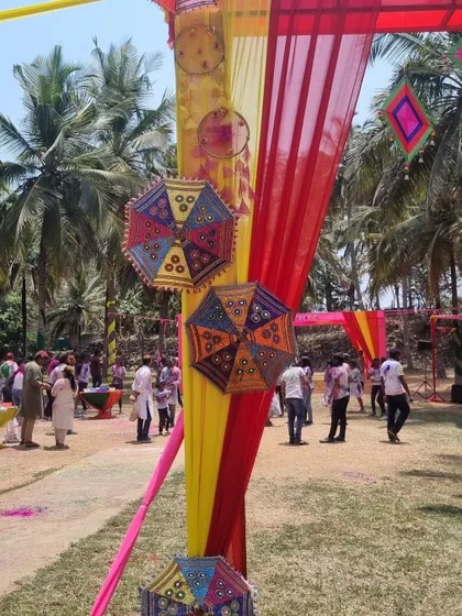 Guests walking through the decorated entrance, giving a sense of the lively atmosphere at the Giva corporate Holi event.