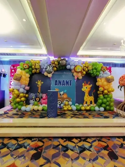 The main stage for Anant's jungle-themed mundan ceremony. I designed a large backdrop with animal cutouts and a full organic balloon arch to create an immersive experience.