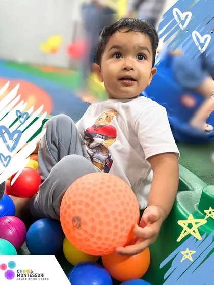 A moment of fun in the ball pit. Free play is essential for toddlers to explore their environment, interact with peers, and simply enjoy being children.