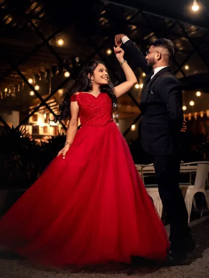 A dance under the stars. This couple's pre-wedding shoot is full of romance, with the bride in a classic red ball gown and the groom in a sharp suit.