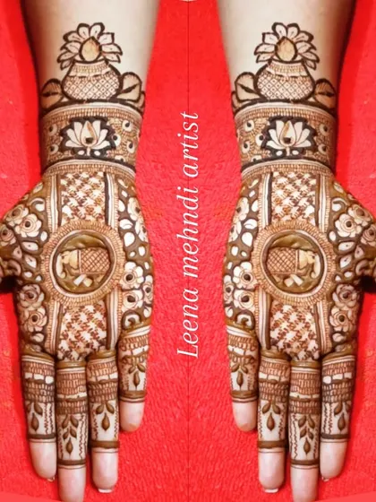 A traditional design featuring an elephant inside a central circle, with a kalash motif on the wrist.