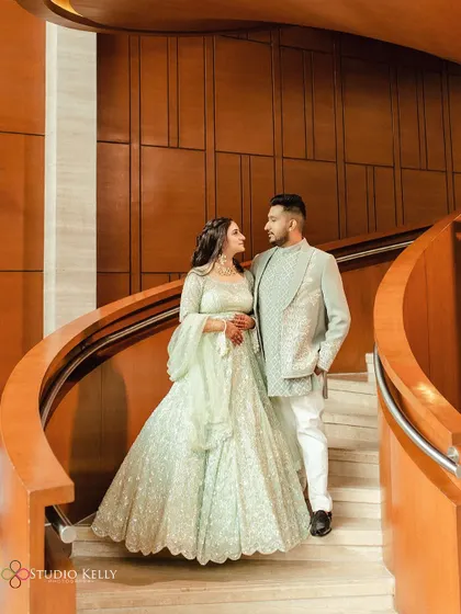 A beautiful portrait of the couple on a spiral staircase, showcasing the bride's stunning lehenga.