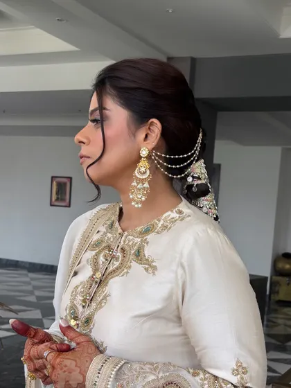 An identical shot to the previous one, showing the elegant side profile and how the hair accessories connect seamlessly from the side of the head to the braid itself.