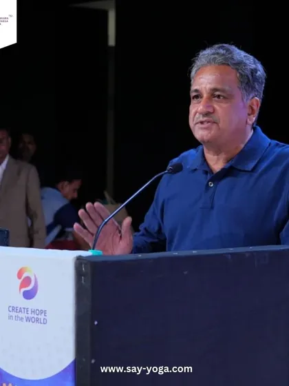 Our founder, Mr. Chandrashekar, addressing the audience at the Rotary International event. His passion for sharing the gift of yoga is at the heart of everything we do at SAY Yoga.