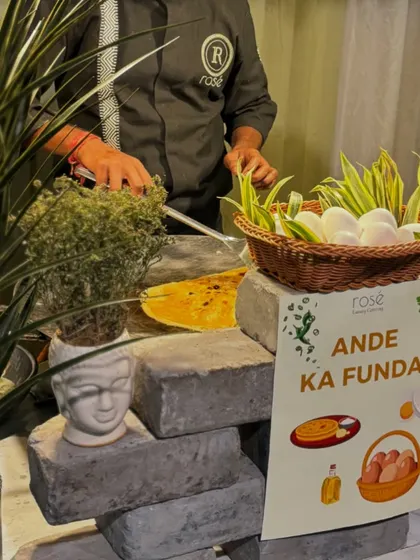 A playful and rustic setup for our "Ande Ka Funda" live egg station. The use of concrete blocks and potted plants creates a unique aesthetic that makes the station a visual point of interest.