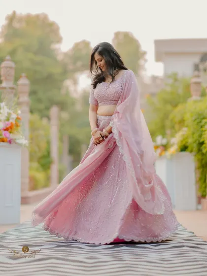 A beautiful solo portrait of the bride-to-be, her lavender lehenga twirling around her. This shot captures her grace and happiness.
