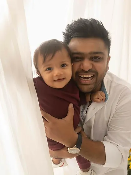 Peek-a-boo! A fun and candid shot of a father and son playing behind a curtain, full of laughter and joy.