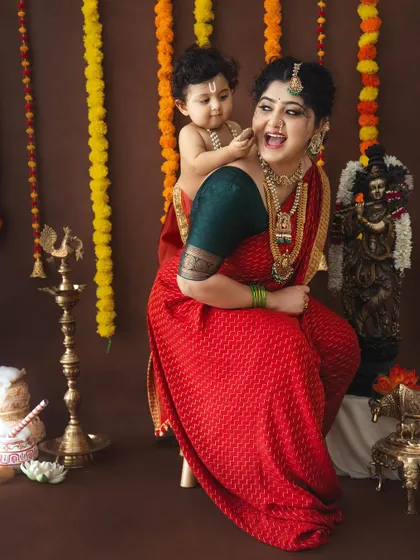 A playful and candid moment between a mother and her baby Krishna.