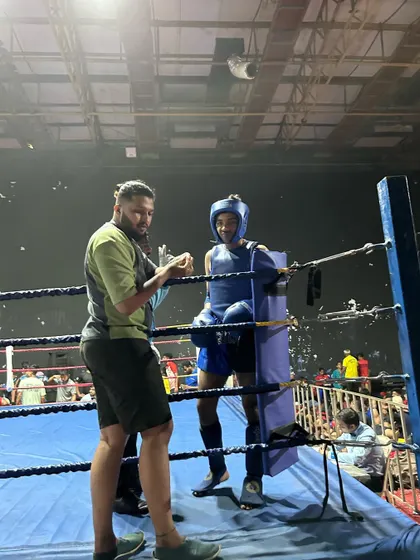 A moment of focus between coach and fighter during a high stakes match. Clear communication is key to victory.