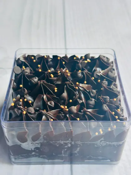 A side view of the Chocolate Overload tub, which features layers of rich chocolate cake, chocolate mousse, and chocolate chips.