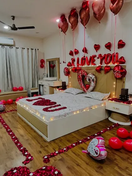 An angled view showcasing the scale of the room decoration. We cover the floor with balloons and create a beautiful heart shape with rose petals, making the entire space feel like a private celebration.