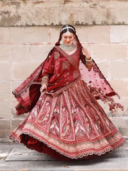 A beautiful shot of the bride twirling, her lehenga in full flare. We love capturing the grace and movement of our brides.