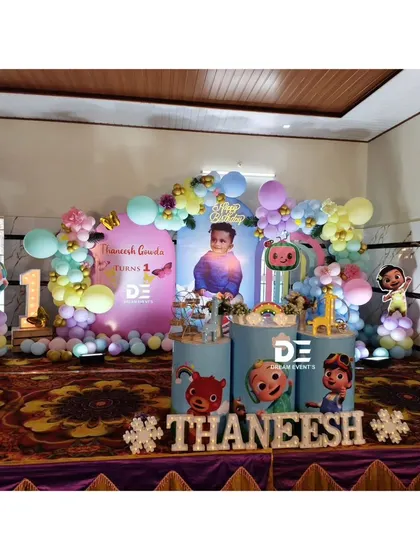 Another view of the Cocomelon party stage, showing the full setup with the birthday boy's name in large snowflake-accented letters.