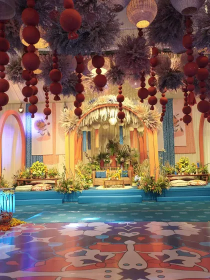 We transported guests to a Moroccan nightfall for this Mehendi. The rich blues and oranges, the custom-printed dance floor, and the dramatic overhead installations all came together to create a truly immersive and magical atmosphere.