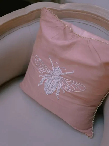 Details make the difference. For one wedding, we created custom upholstery with this beautiful hand-embroidered bee motif, adding a personal and whimsical touch to the decor.