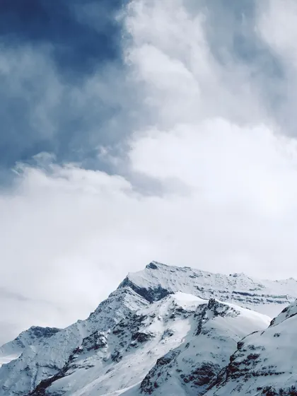 Dramatic clouds over the snow-covered peaks of the Himalayas. The weather in the mountains can change in an instant, providing endless opportunities for dramatic photography.