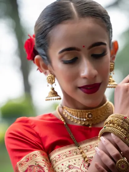 A portrait highlighting the beautiful gold bangles and rings from a jewelry campaign.