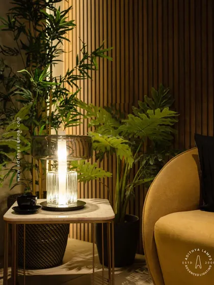 An elegant table lamp designed with a fluted crystal base and a smoked glass upper shade. This piece combines classic materials with a modern form to create a sophisticated light source for a living room or bedroom.