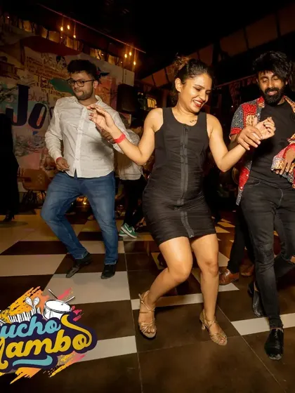 A trio enjoying the vibrant beats. Our socials often feature line dances or group animations to get everyone involved and laughing together.