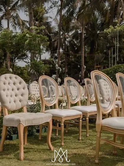 A mix of classic tufted chairs and modern transparent chairs for guest seating, adding visual interest while maintaining an elegant, neutral palette.