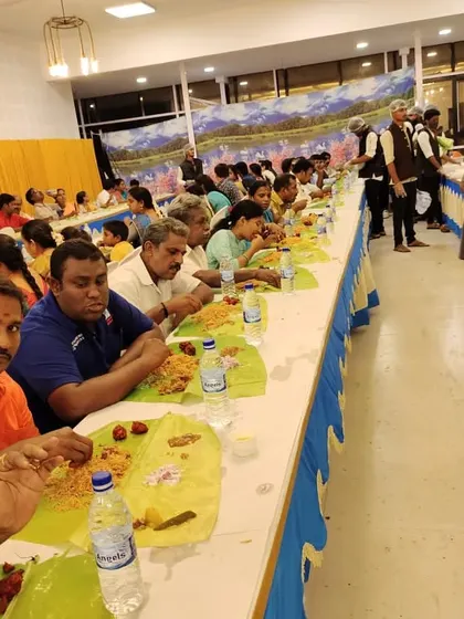 A wide shot of guests enjoying our catering service. We ensure there is ample space and efficient service for a comfortable dining experience.