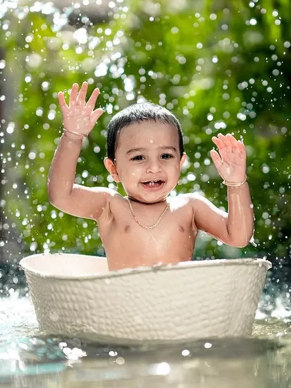 Waving hello from the water! This happy baby is having a fantastic time during his splash session.
