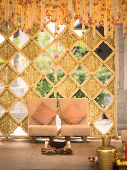A closer look at the seating for a royal wedding tale. We designed this space with simple, elegant chairs and cushions that complement the intricate floral backdrop, ensuring every guest has a perfect view of the ceremony.