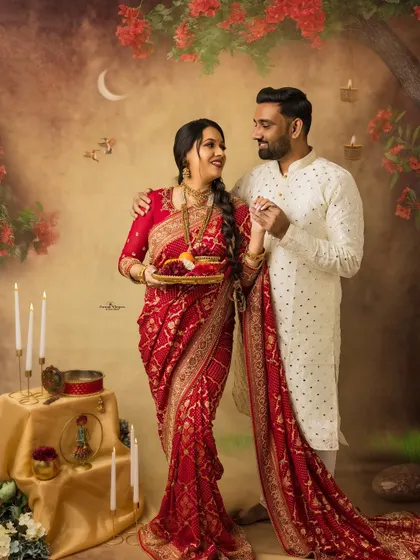 A joyful and romantic portrait from a Karva Chauth themed session. The couple's dance-like pose and happy expressions perfectly capture the celebratory mood of the festival.