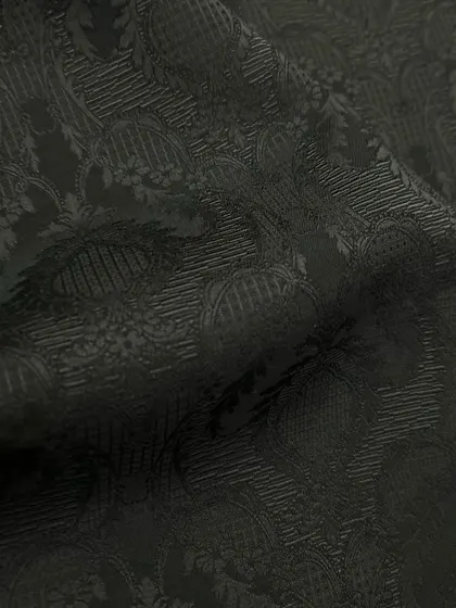 A close-up of a black-on-black patterned fabric, perfect for adding subtle elegance to an evening jacket or sherwani.